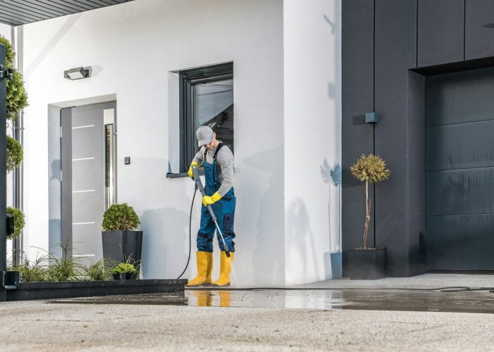Men Cleaning His House Surrounding Using Pressure Washing Machine